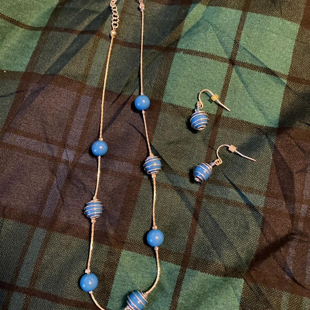 Silver necklace and earrings with turquoise colored stones.